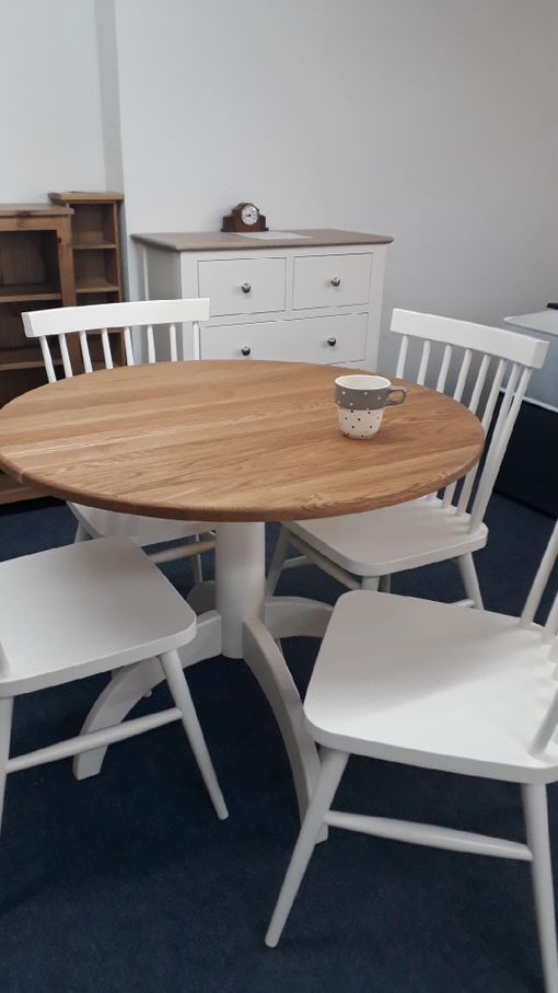Painted bistro set. Finished in old white with solid oak top. Round pedestal table and 4 stick back chairs £595